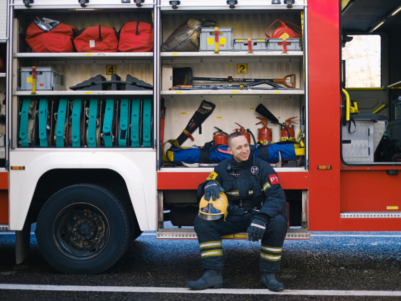 Local Firefighter sitting by fire truck